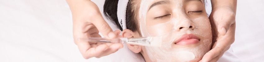 A woman having a chemical peel facial treatment.