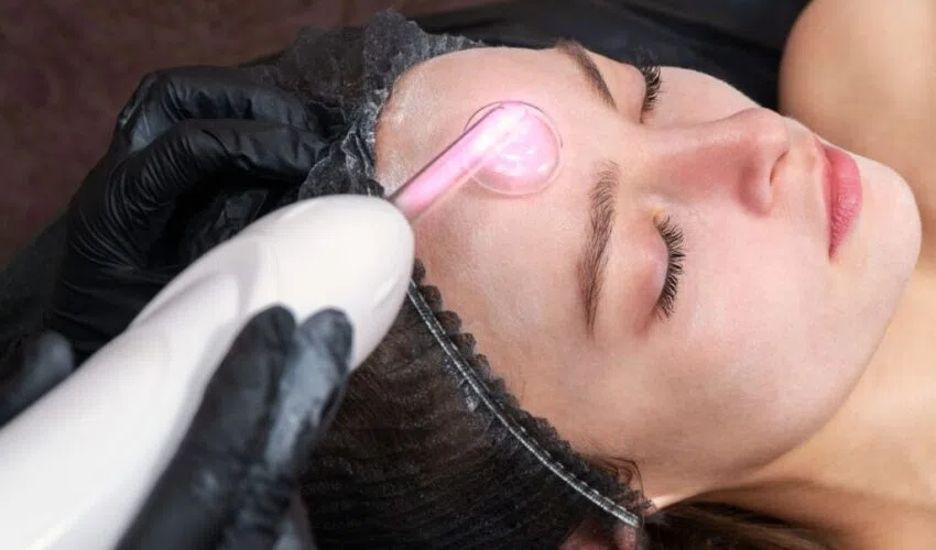 A woman undergoes a high-frequency facial.