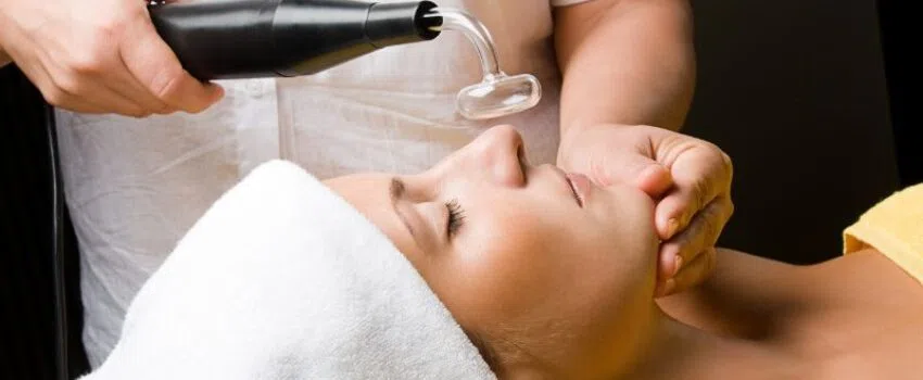 A woman undergoes a high-frequency facial to reduce fine lines and wrinkles.