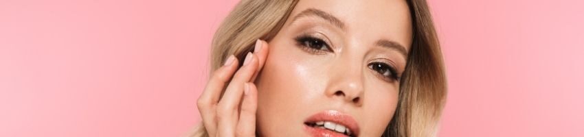 woman with long blonde hair standing isolated after using aloe vera on her face