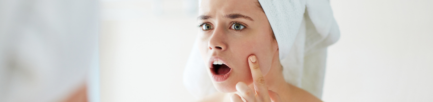 A picture of a woman shocked how baking soda and coconut oil benefits her face