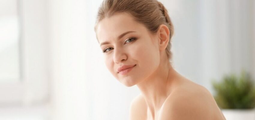 Female Applying Facial Moisturizer to her skin to prevent acne