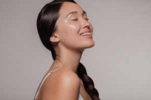 Woman smiling to show off her glowing skin