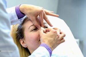 A woman going through a procedure to make her nose smaller.