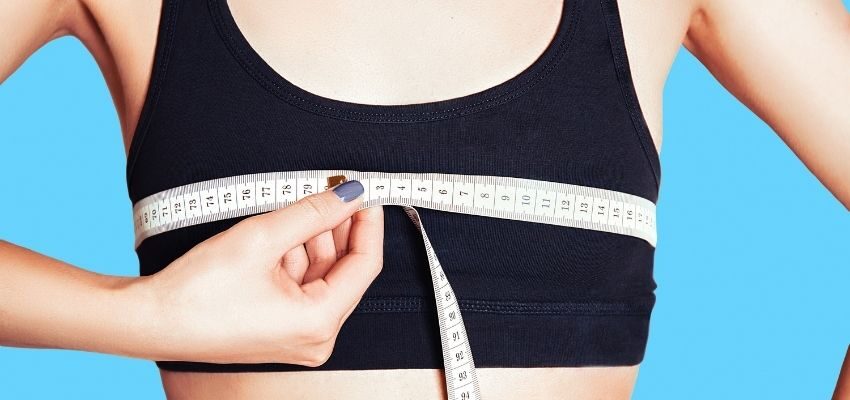 A woman measuring her breast size.