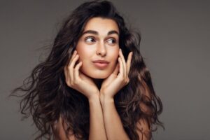 A woman thinking about getting ablative vs. non-ablative laser resurfacing.