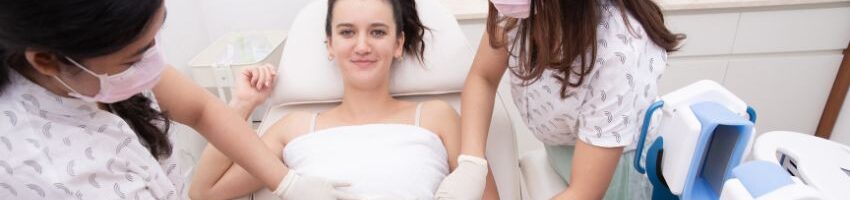 a woman having a breast lift treatment in bed with 2 staffs