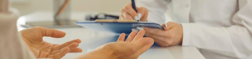 hands of a doctor and a patient with the doctor writing in a piece of paper