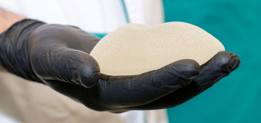 A surgeon holding the implants that will place in the patient's breast.