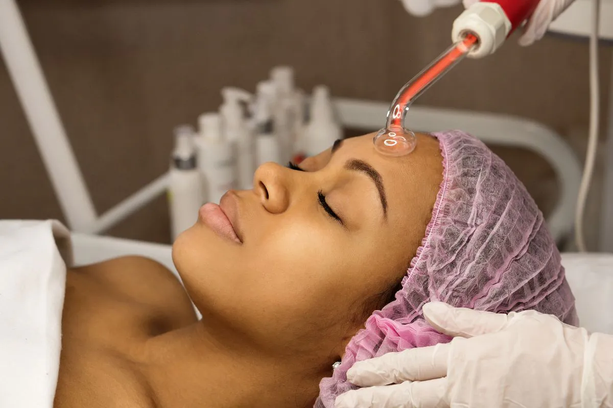 The woman undergoes a high-frequency facial.