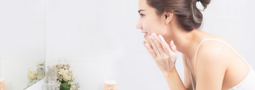 The woman use a non-toxic body wash to clean her face.