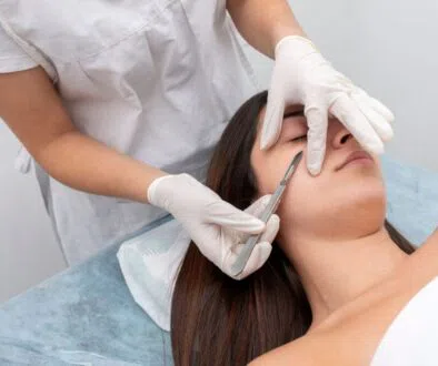 The woman tries dermaplaning to have smooth skin.