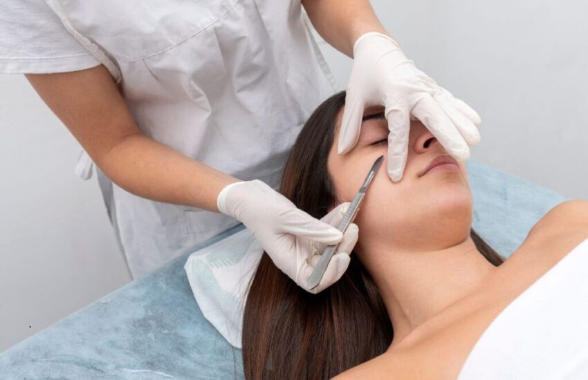 The woman tries dermaplaning to have smooth skin.