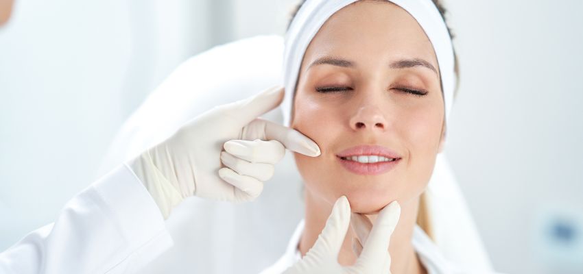 botox-injection-sites1 Medical professional assessing botox injection sites on a relaxed female patient.
