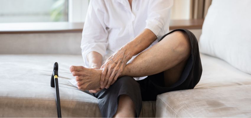 why are my ankles dark (3) The older woman applies moisturizer to her feet to prevent dark ankles.
