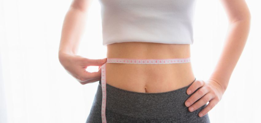 coolsculpting3 A woman measuring waist after undergoing several CoolSculpting sessions.