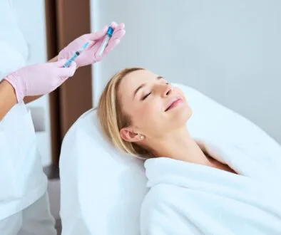 Woman receiving platelet rich fibrin (PRF) treatment for skin rejuvenation.